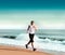 Young woman jogging on the beach