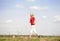 Young woman jogging on a dirt road