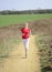 Young woman jogging on a dirt road