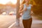 Young woman jogging on pavement in the morning