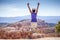 Young woman joyfully jumping in Bryce Canyon Park