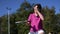 Young woman juggling with a ball and pickleball paddle on a court in slow motion video clip