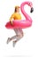 Young woman jumping with a big inflatable flamingo rubber ring