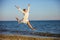 Young woman jumping with joy on beach