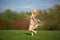 Young woman jumping on meadow