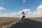 Young woman jumping on the road on nowhere