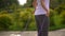 Young woman is jumping rope in the park. Close up of her feets and buttocks. slow-motion