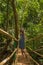 Young woman in the jungle on the bridge in tropical spice plantation, Goa, India