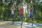 Young woman and kids performing yoga