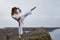 Young Woman in Kimono practicing karate