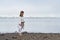 Young Woman in Kimono practicing karate on river coast