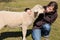 Young woman kissing little lamb