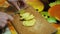 Young woman in the kitchen cutting the potatoes with knife on wooden cutting board