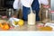 Young woman in kitchen with grocery shopping in bulk.