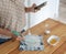 A young woman in the kitchen is preparing a dessert and watching a recipe on a smartphone on the Internet, cooking at home,