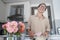 Young woman in the kitchen preparing dessert and watching a recipe in a smartphone on the Internet, cooking at home, hobbies and