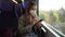 Young woman with KN95 FFP2 face mask using smart phone app. Train passenger with protective mask traveling sitting