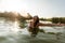 Young woman in lake with arms outstretched