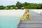 Young woman landing stage on beach on Maldives