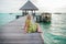 Young woman landing stage on beach on Maldives