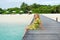 Young woman landing stage on beach on Maldives