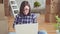 Young woman with laptop on background of boxes and construction works