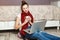 Young woman with laptop and coffee