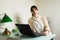 Young Woman with Laptop Computer Contemplating