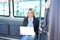 Young woman with a laptop inside a bus