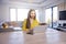 Young woman with laptop sitting at desk and workin at home