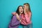 Young woman laughing while her friend whispering something funny