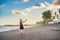 A young woman launches a kite on the beach. Dream, aspirations, future plans