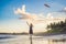 A young woman launches a kite on the beach. Dream, aspirations, future plans