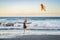 A young woman launches a kite on the beach. Dream, aspirations, future plans