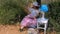 Young woman laying reading a book under the tree