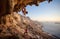 Young woman lead climbing along a roof in cave