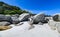 A young woman leaning on the boulders of clifton beach in the capetown area of south africa.