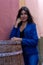 Young woman leaning on a wine barrel used as a table in a restaurant