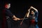 Young woman learning kendo fighting with teacher