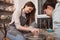 Young woman learning from professional potter