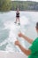 Young woman learning to water skiing on lake