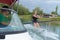 Young woman learning to waterski with instructor