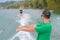 Young woman learning water ski with coach