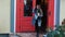 A young woman is leaving a cafe or a bookstore with a book in the hand