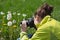 Young woman in leisure time making nature photos in the grass.