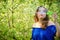 A young woman lets soap bubbles on the background of a flowering tree, copy space for text