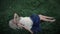Young woman lies on the grass