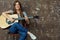 Young woman lifestyle portrait with guitar.