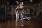 Young woman lifting barbell with light weights at gym. Fitness female doing crossfit workout