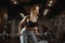 Young woman lifting barbell with light weights at gym. Fitness female doing crossfit workout